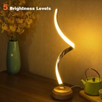 LED table lamp on a wooden base with five brightness levels, placed on a table beside a vase and teapot
