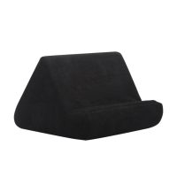 Black velour pillow tablet holder with angled back and rounded front support.