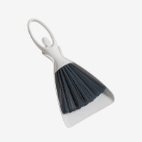 Mini desktop cleaning brush set in white and gray, stored neatly in its compact dustpan.