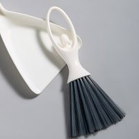 Close view of the brush's unique ergonomic handle loop and hanging hook feature.