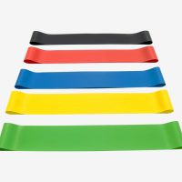 Five flat loop resistance bands neatly laid out in parallel on a white background