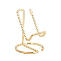 Metallic gold phone stand on white background