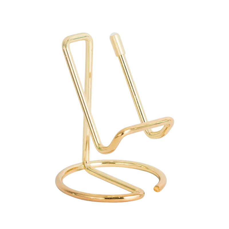 Metallic gold phone stand on white background