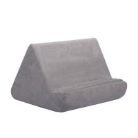 Gray velour pillow tablet holder with angled back and rounded front support.