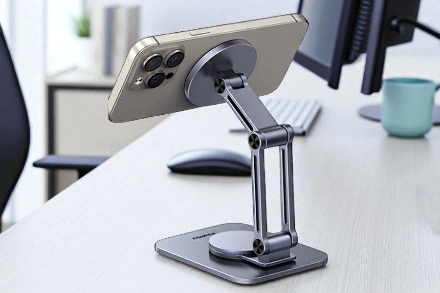 Magnetic desktop stand Adjustable magnetic phone stand with MagSafe mount holding an iPhone at an ergonomic angle on a desk with computer setup.