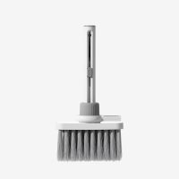 White multifunctional keyboard cleaning kit with keycap puller and earbud cleaning pen attached.