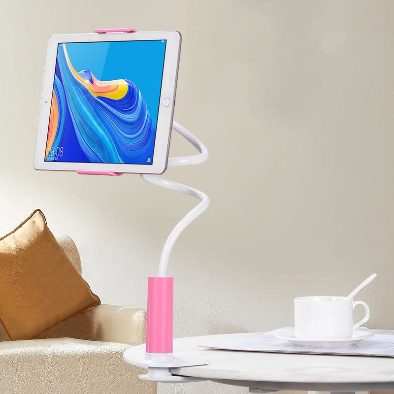 Clamp-on gooseneck for tablets and phones Flexible gooseneck stand with pink accents holding a tablet, secured with a clamp-on base to a table edge.