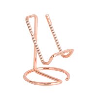 Metallic rose gold phone stand on white background