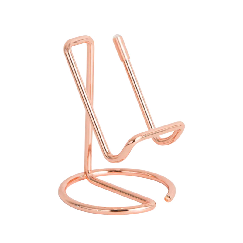 Metallic rose gold phone stand on white background