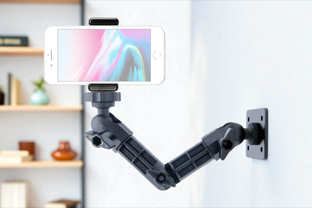 Articulating arm mount Wall-mounted articulating arm holding a smartphone with adjustable joints positioned against a blurred interior background.